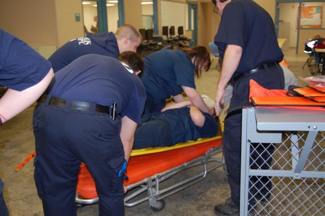 Photo of students doing a simulation in the Emergency Medical Technician program